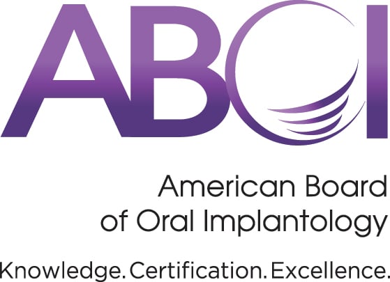 The logo for the American Board of Oral Implantology (ABOI) featuring large purple letters and the organization's full name below.