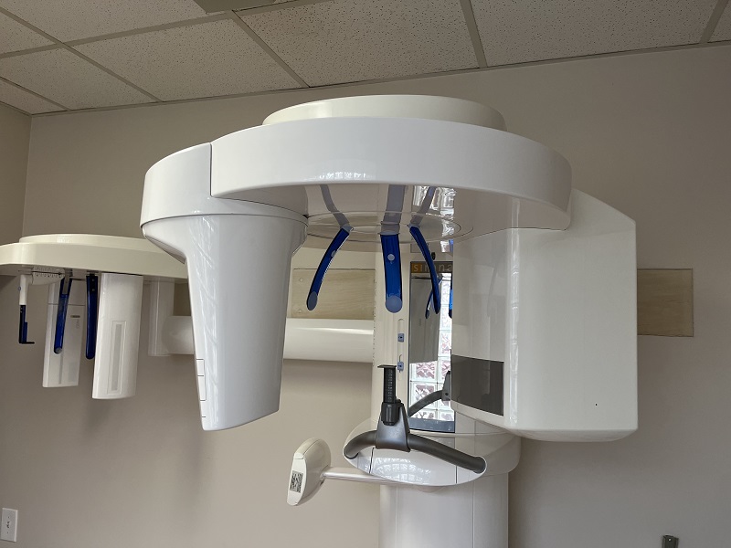 A white panoramic dental X-ray machine used for capturing full-mouth digital images of a patient's teeth and jaw.